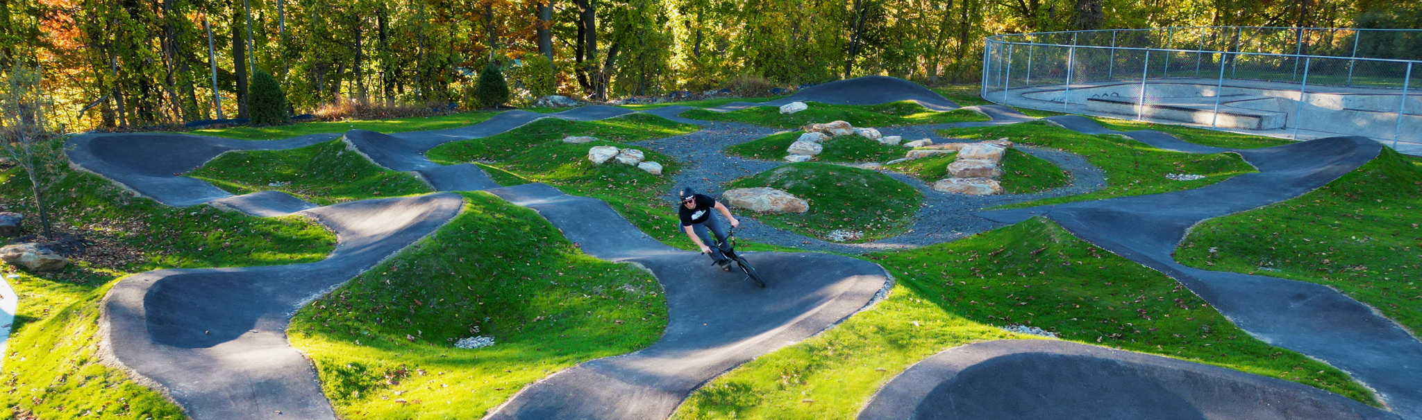 A picture of a person using the bicycle pump track at Boyce Park.