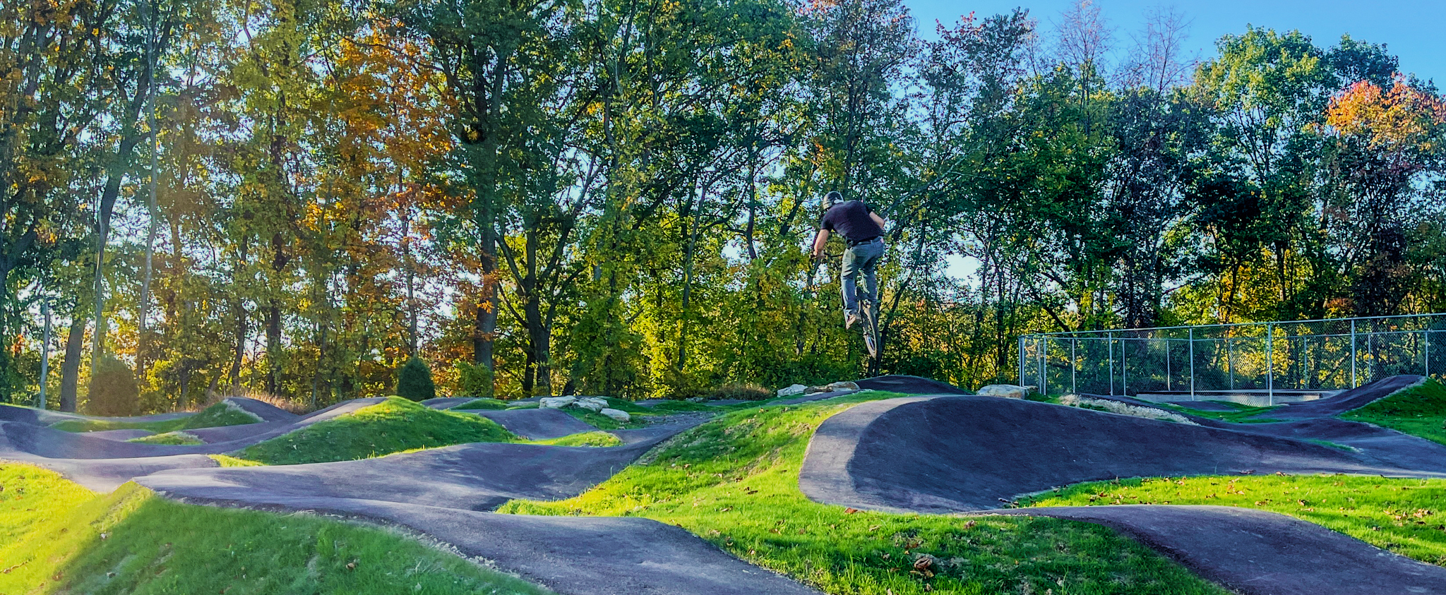 A picture of a person using the bicycle pump track at Boyce Park.
